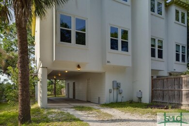 The townhouse is a two story stucco exterior with 
