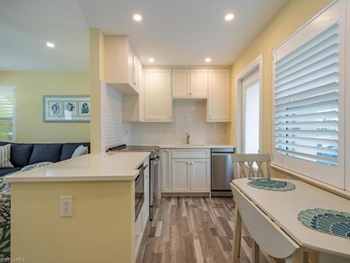 The bright kitchen features updated flooring, appliances and cabinetry.