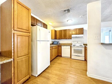 Kitchen with visible vents, light wood-style floo