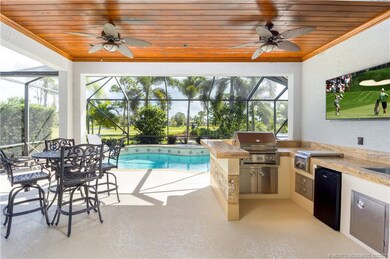 Outdoor Kitchen nestled under solid wood Ceiling w