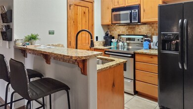 Kitchen with light tile patterned flooring, a brea