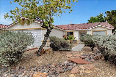 Ranch-style house with a garage, a tiled roof, and