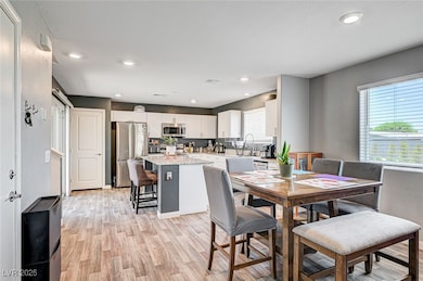 Dining space with light wood finished floors and r