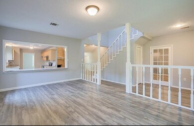 Formal Dinning area. Storage nook under the stairs could be a great pet room!