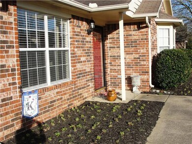 Well maintained landscaping including Rosebushes, Pansies, American Holly, and Oak