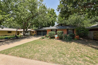 View of front of home with a front lawn and a gara
