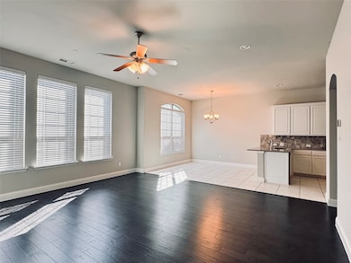 Unfurnished living room with a ceiling fan, light wood-style floors, a chandelier, and recessed lighting