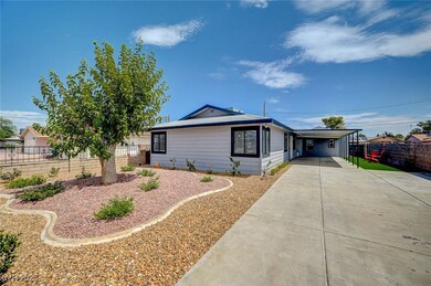 View of front of home with concrete driveway and an attached carport