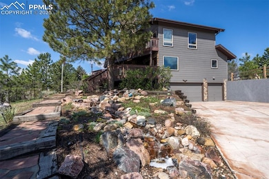 View of side of home with an attached garage, concrete driveway, and stairway