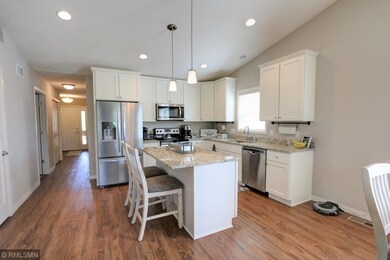 Bright Kitchen with granite counter tops and vault