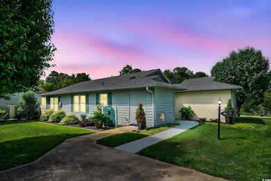 Single story home featuring a front lawn and a shingled roof