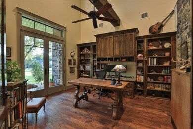 FORMAL STUDY WITH GORGEOUS BUILT INS AND HAND SCRAPED  WOOD FLOORS! 2 SETS OF FRENCH DOORS! ONE LEADS TO COVERED FRONT PORCH AND ONE TO ENTRY!
