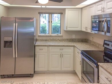 Kitchen with ceiling fan, light stone countertops,