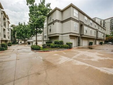 View of property featuring driveway and a garage