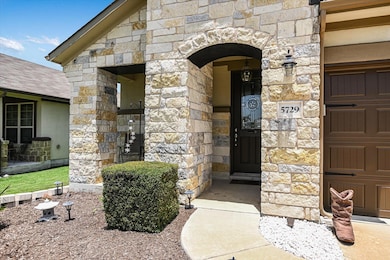 Doorway to property with stone siding