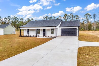 View of front of property with covered porch, a ga