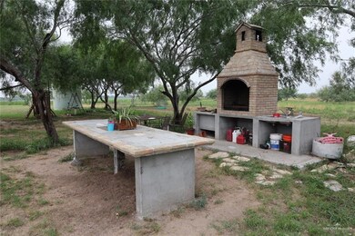 View of yard featuring an outdoor fireplace