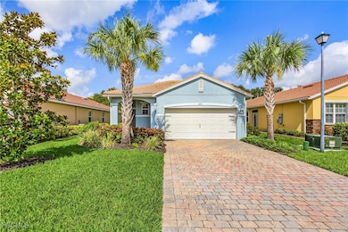 View of front facade featuring an attached garage, decorative driveway, a front yard, stucco siding, and a tiled roof