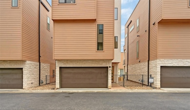 View of front of home with stone siding, fence, a