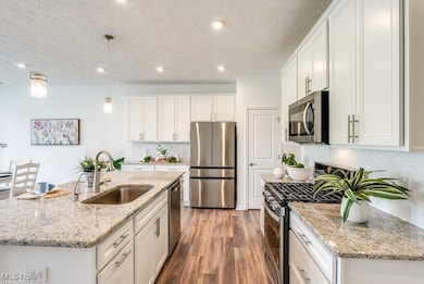 Cooking is a pleasure in this airy, open kitchen. Lots of counter space for prepping. Ample storage in cabinets and drawers. Many of the cabinets have pull out shelves.