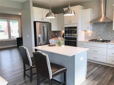 Elegant kitchen with large gas cooktop and french 