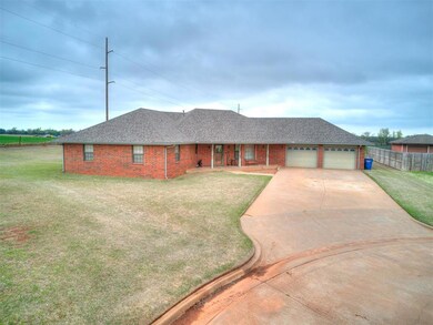 Ranch-style house featuring a front lawn and a gar