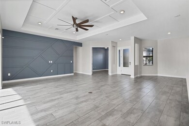 Unfurnished living room featuring a raised ceiling