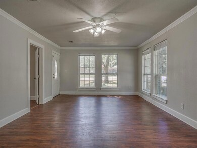 Large living area beyond foyer. All rooms with 5 inch baseboards and most with crown molding