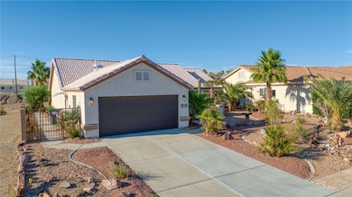 View of front facade with driveway, stucco siding,