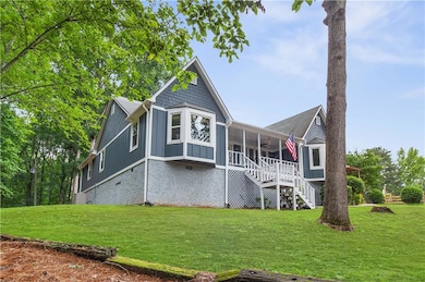 Back of house featuring stairs, a ceiling fan, a yard, and board and batten siding