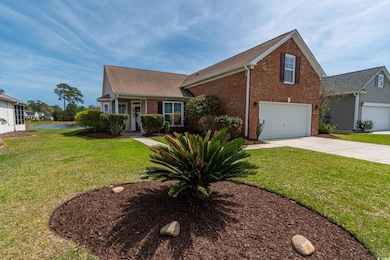 View of front of house featuring brick siding, a g