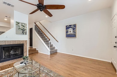 Unfurnished living room featuring stairway, a cei
