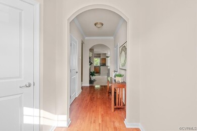 Corridor with ornamental molding and light hardwoo