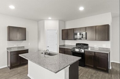 Kitchen with stainless steel microwave, black ran