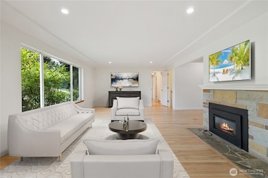 Home Opens to a Large Inviting Living Room with Cozy Fireplace