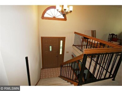 The entry door features a stained glass insert and
