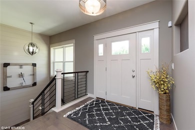 Large and Inviting Foyer with shiplap accent wall 