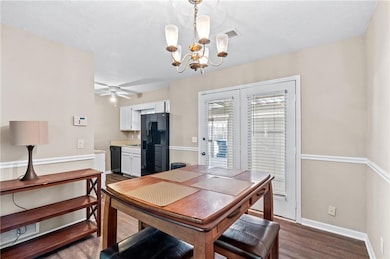 Dining area featuring baseboards, dark wood-style 