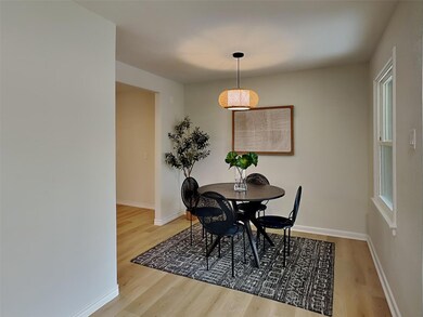 Dining space with light wood-style flooring and ba