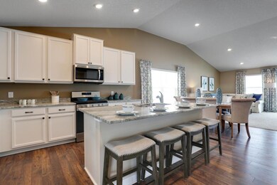 The kitchen is warm, open, and inviting! Model photo, colors and selections may vary.