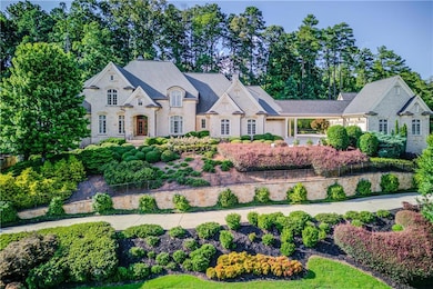 French country style house with stone siding, a ch