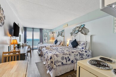 Bedroom with a wall of windows, a textured ceiling, access to outside, dark wood-style flooring, and a wall unit AC