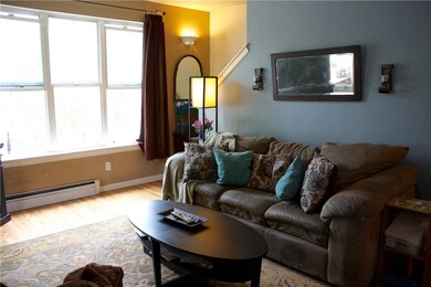Cozy living room with huge windows looking out ont