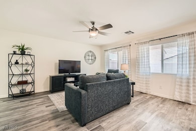 Living room featuring light wood-style flooring and ceiling fan