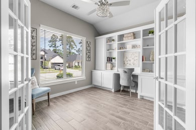 This home office features elegant French doors, a