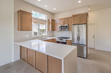 Kitchen featuring stainless steel appliances, a si