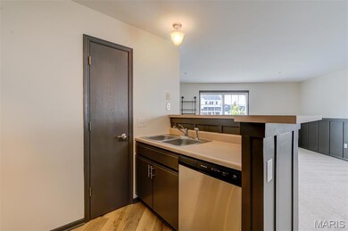 Kitchen has a pantry area and a breakfast bar over the sink and dishwasher.