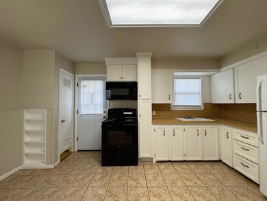 Kitchen featuring visible vents, black appliances,