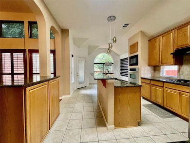 Kitchen featuring stainless steel oven, an island