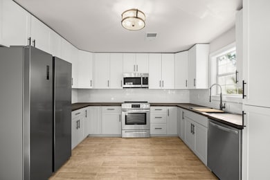 Kitchen with stainless steel appliances, a sink, 